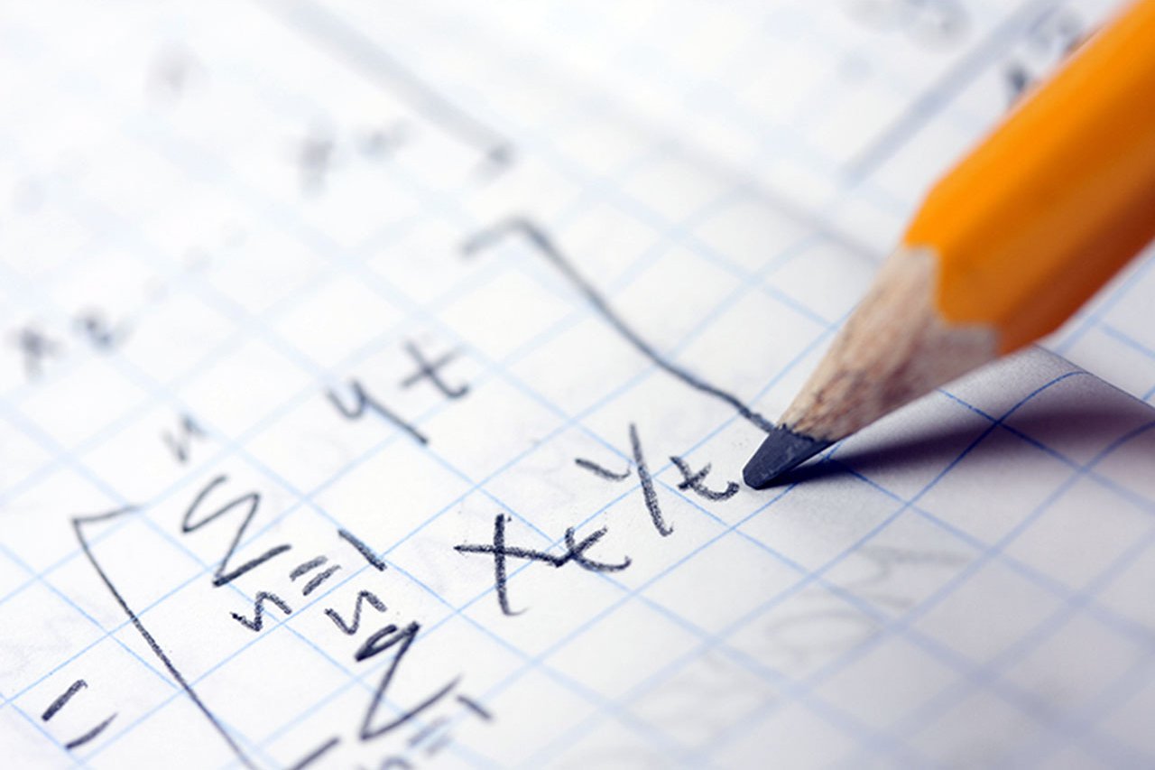 A pencil writing maths equations