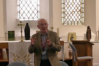 Paul Davies MP delivers a presentation to Novus prison learners in a chapel setting, standing at the front of the room.