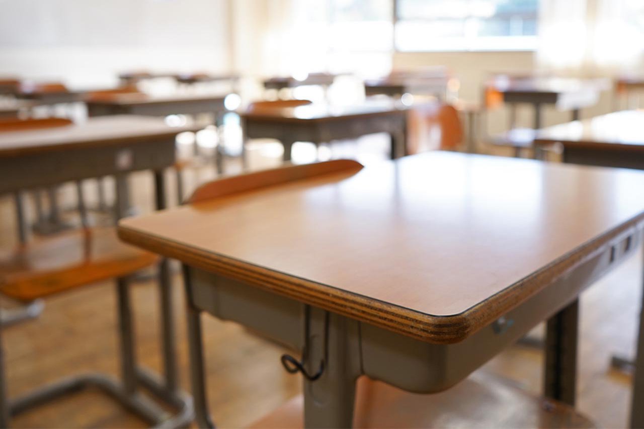 A row of desks in a classroom