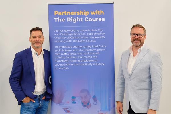 Two people smiling next to a Novus employer partners promotional banner.