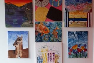 Artwork from HMP Styal learners pinned on the wall for the 'Inspired Inside' art exhibition at the University of Salford