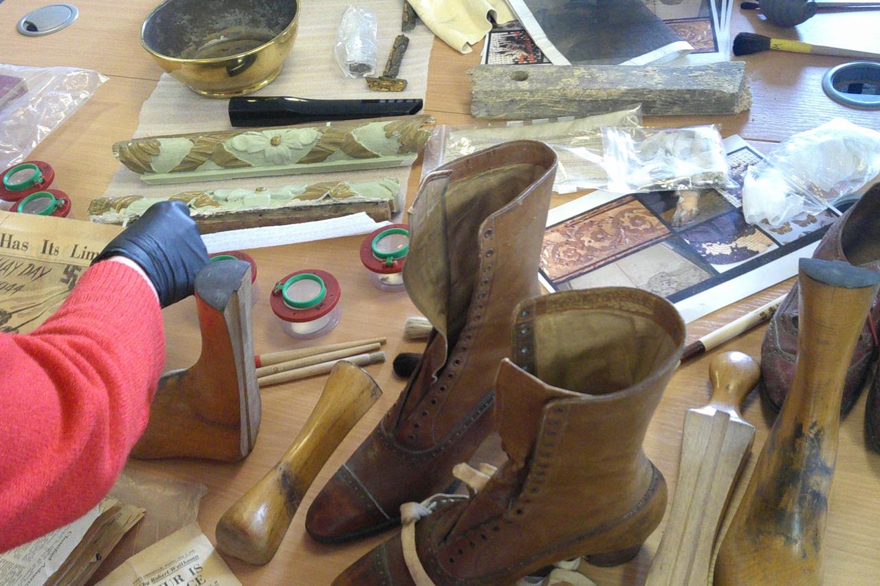 Person working with Bowes museum artifacts