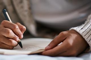 A person writing in a notebook