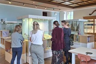 Staff gathered round to look at a museum exhibition at the Bowes Museum