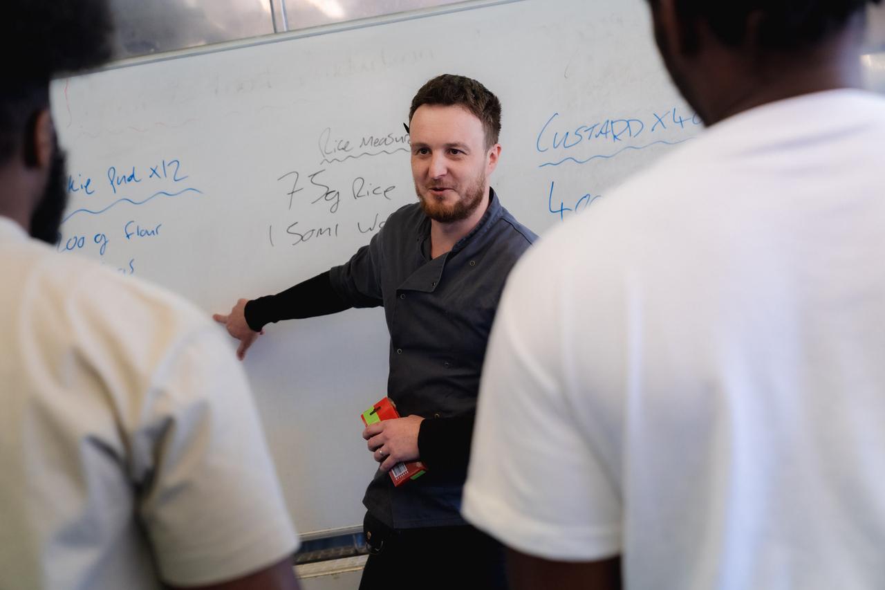 Novus teacher presenting to prison learners