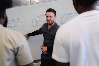 Novus teacher presenting to prison learners