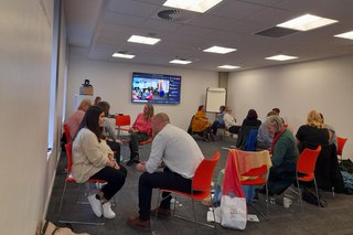 A group of colleagues sat in pairs deep in discussion