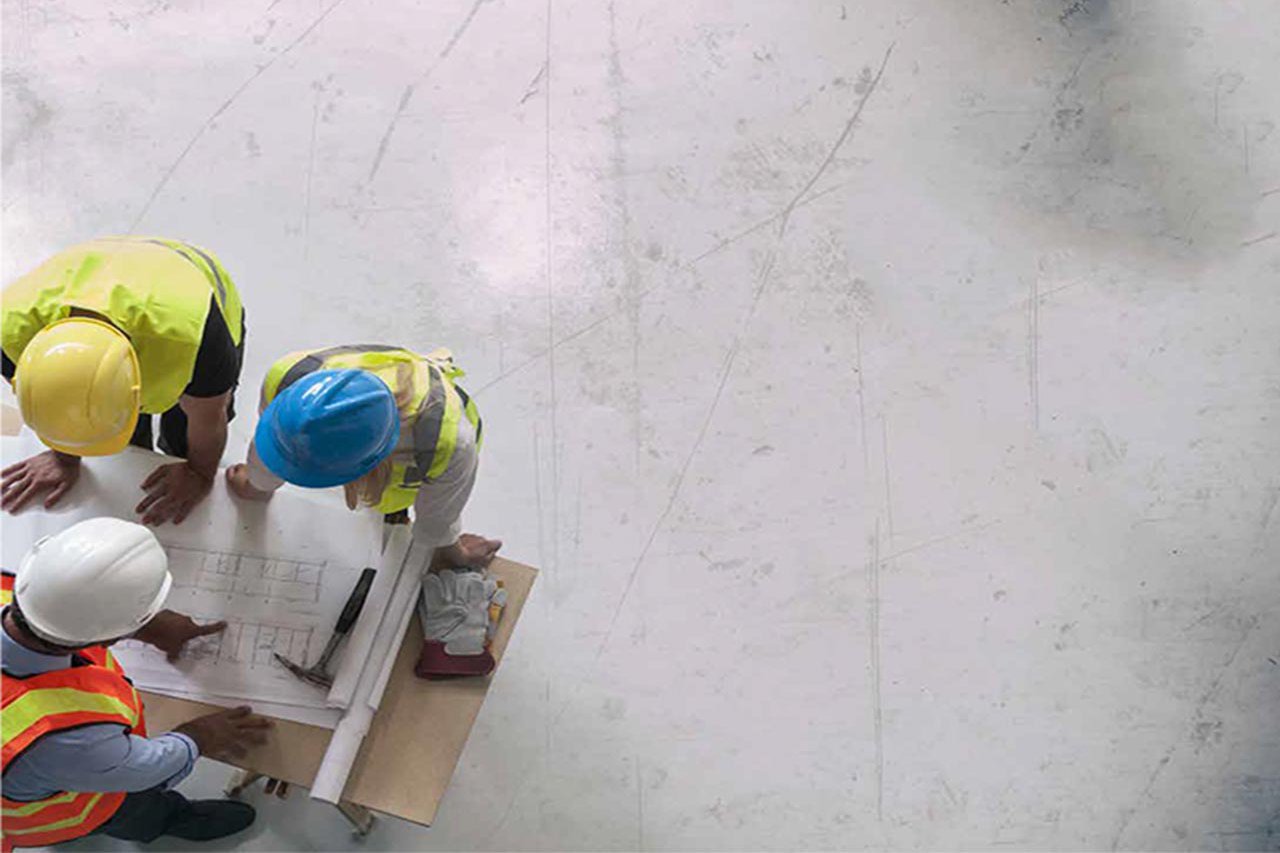 Ariel view of construction workers looking at a diagram