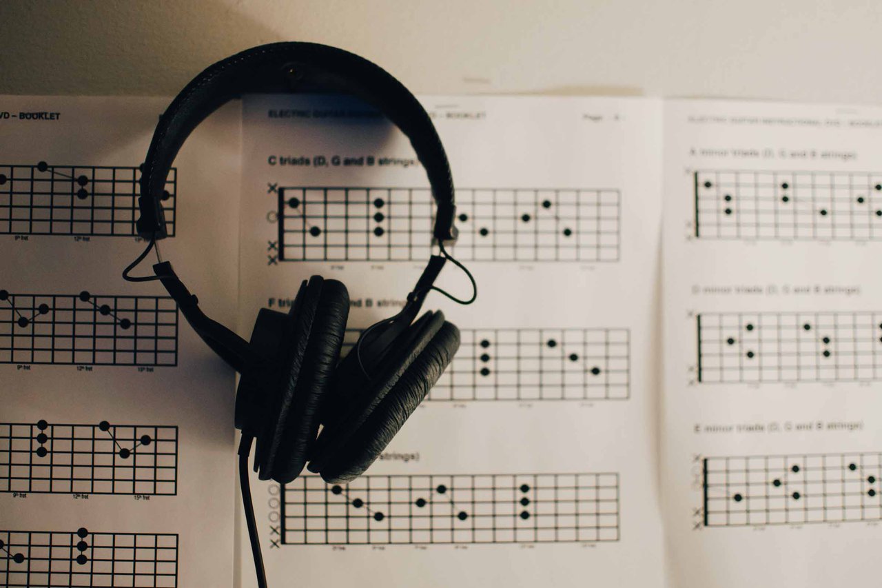 Headphones placed over sheet music