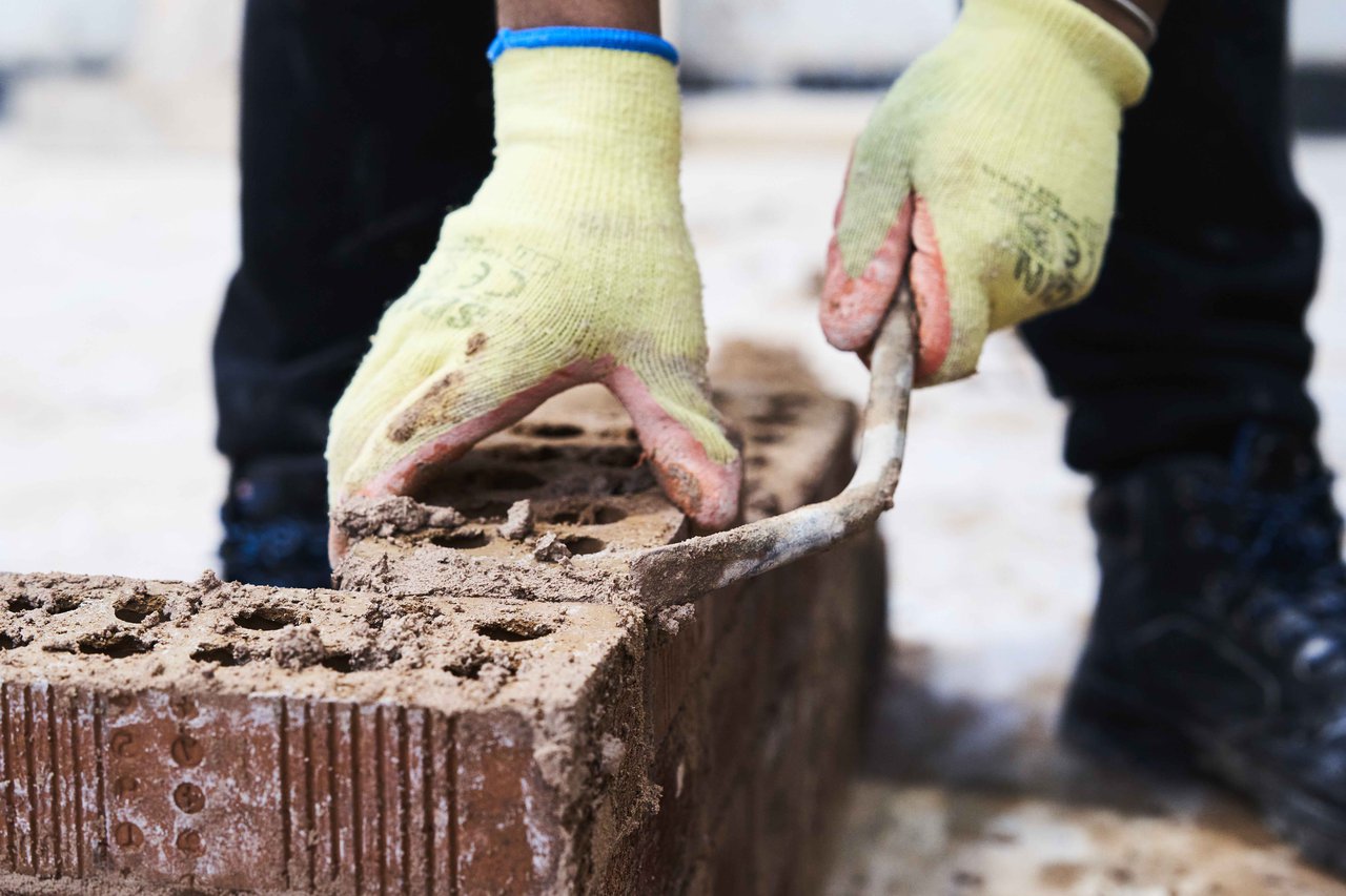 Bricklayer placing brick