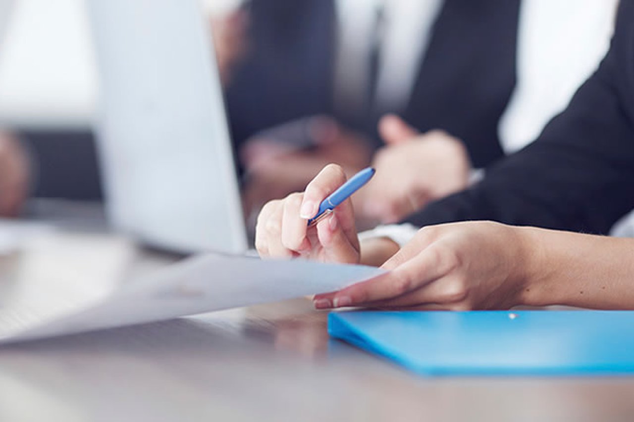 Someone holding a document in an office