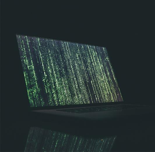 A laptop displaying lines of code