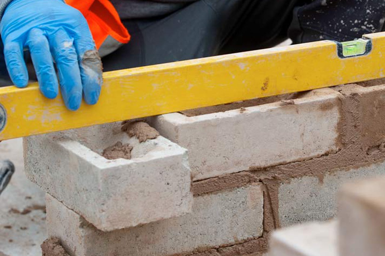 A learner laying bricks