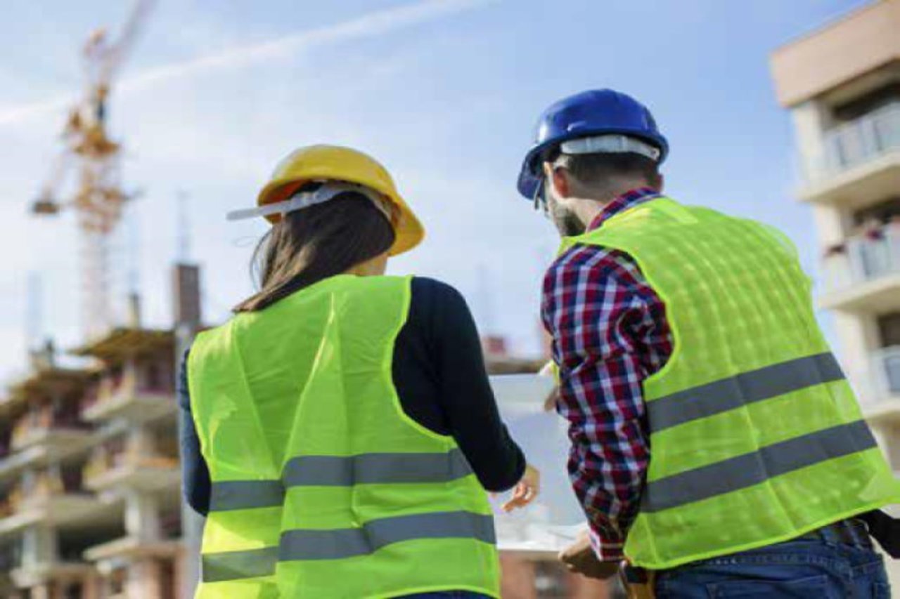 Two construction workers looking at a plan