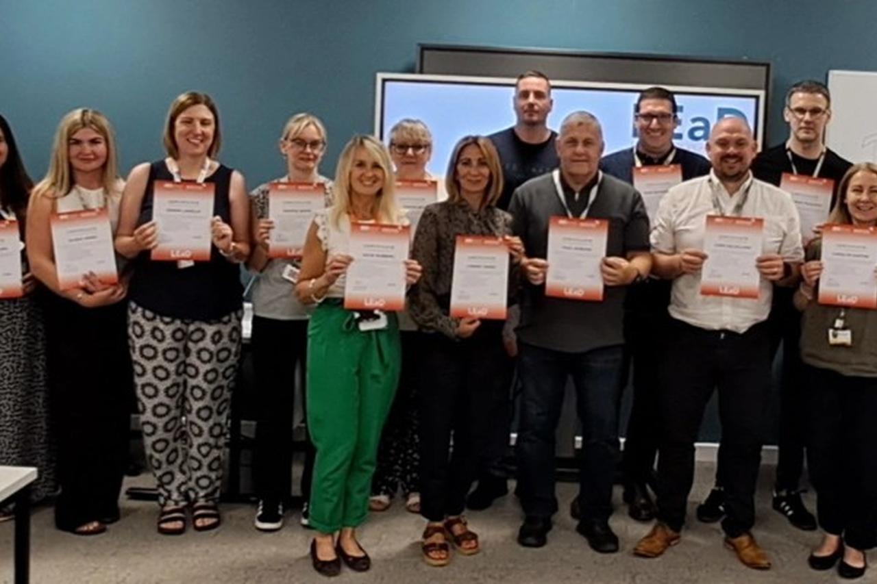 Participants from the first LEaD cohort holding certificates at the programme completion ceremony in July.
