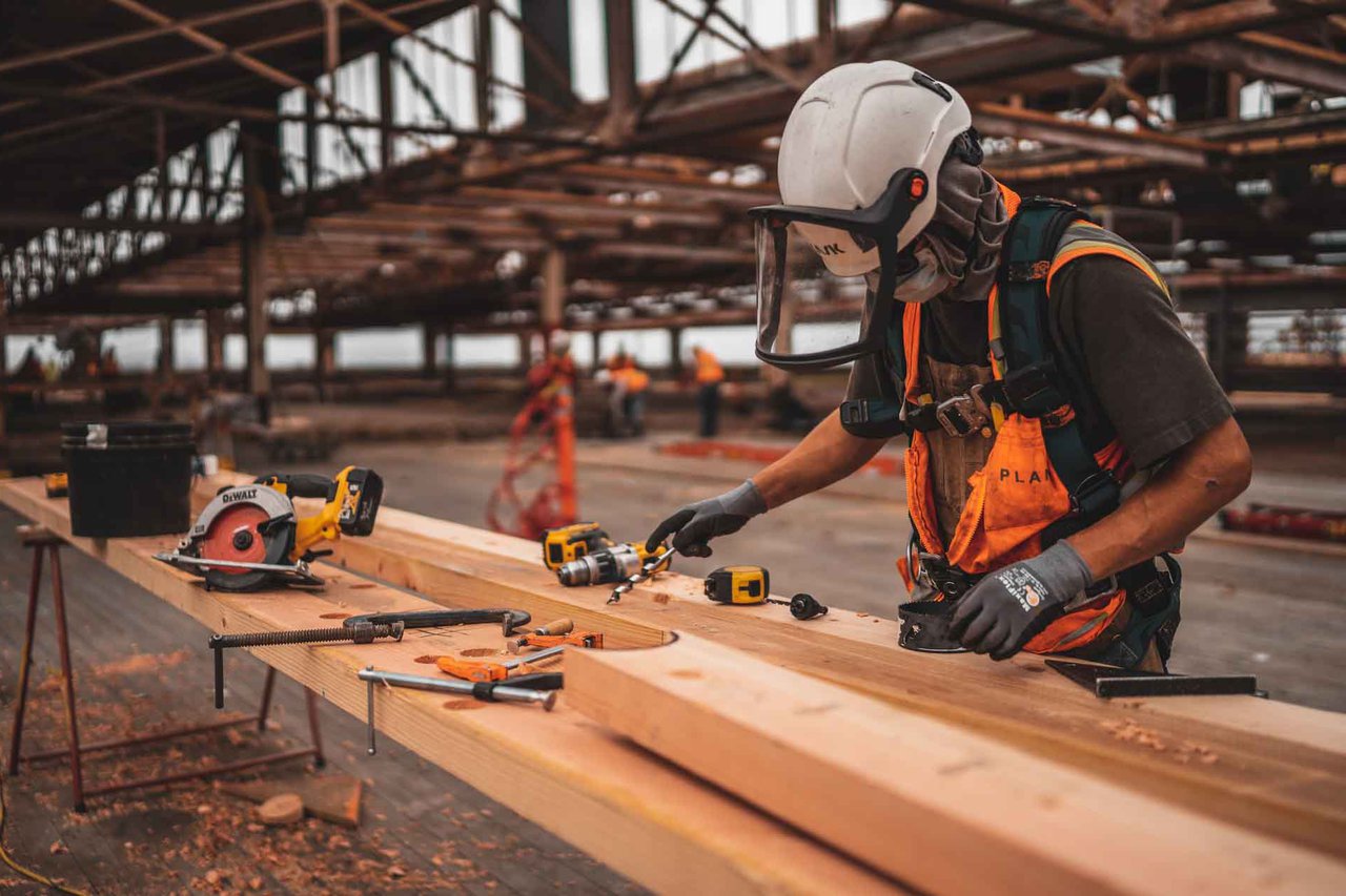 a tradesman drills wood