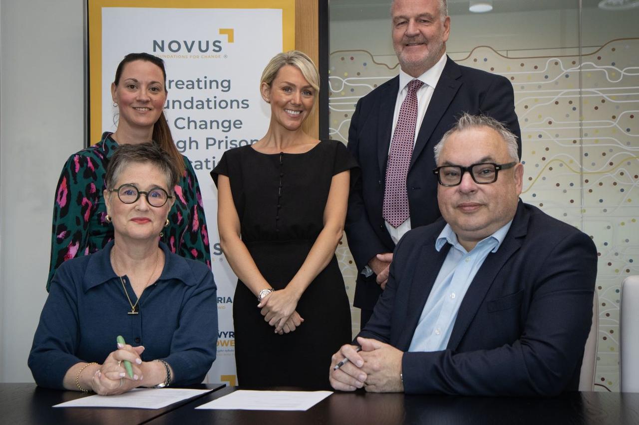 Group of people signing NOvus and UCLan partnership