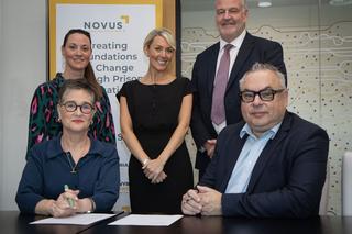 Group of people signing NOvus and UCLan partnership