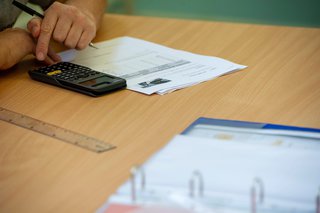 A learner using a calculator to work out a problem.