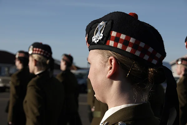 Group of uniformed veterans standing outdoors, representing the 'Veterans' route into prison education and teaching opportunities.