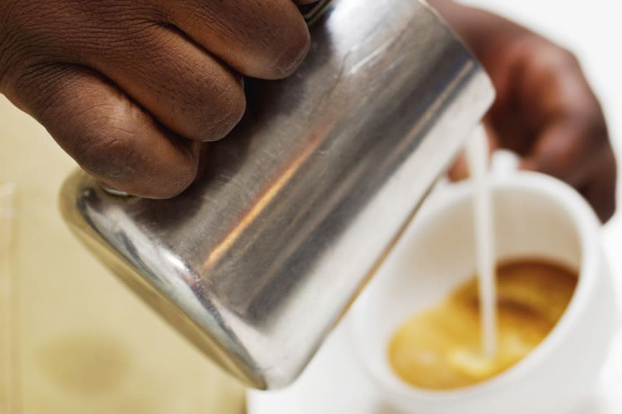 Close-up of someone pouring a coffee