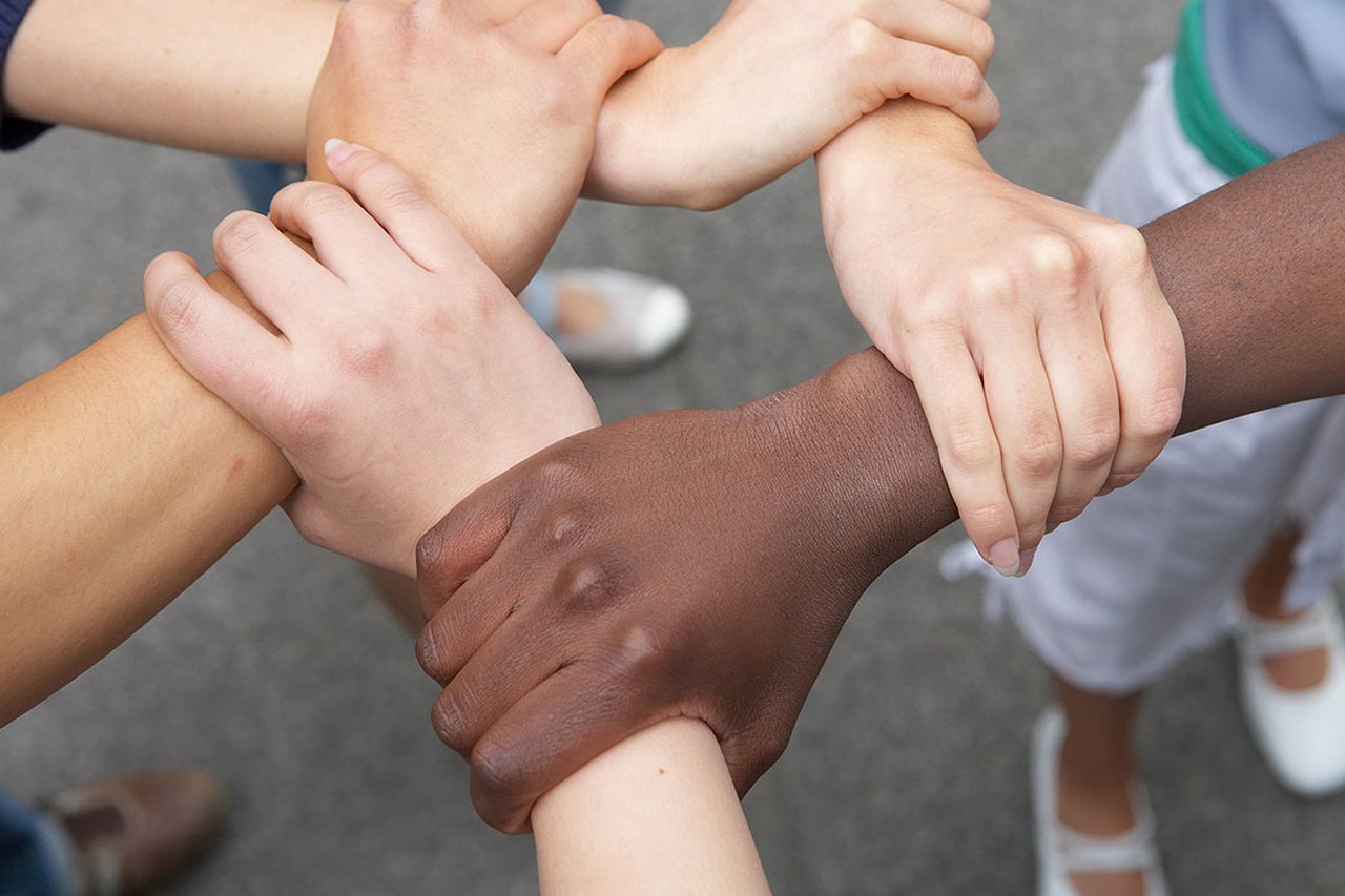 A group of people linking arms