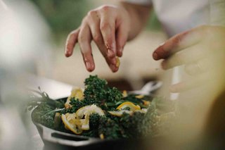 Hands garnishing a dish