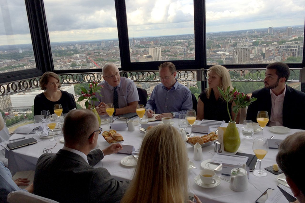 Novus colleagues sat around a table talking