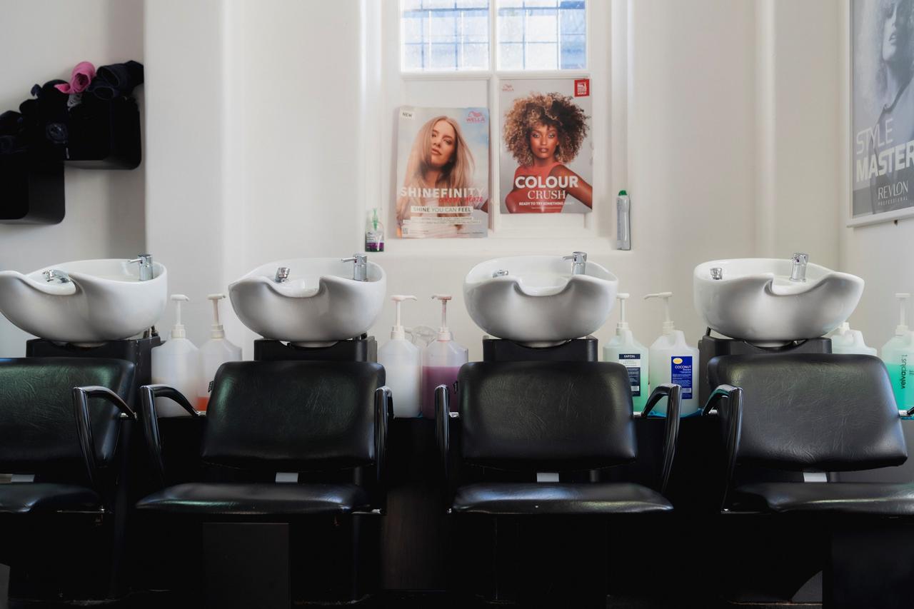 A row of hairdressing chairs and wash basins in a Novus beauty salon
