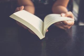 A person holding an open book