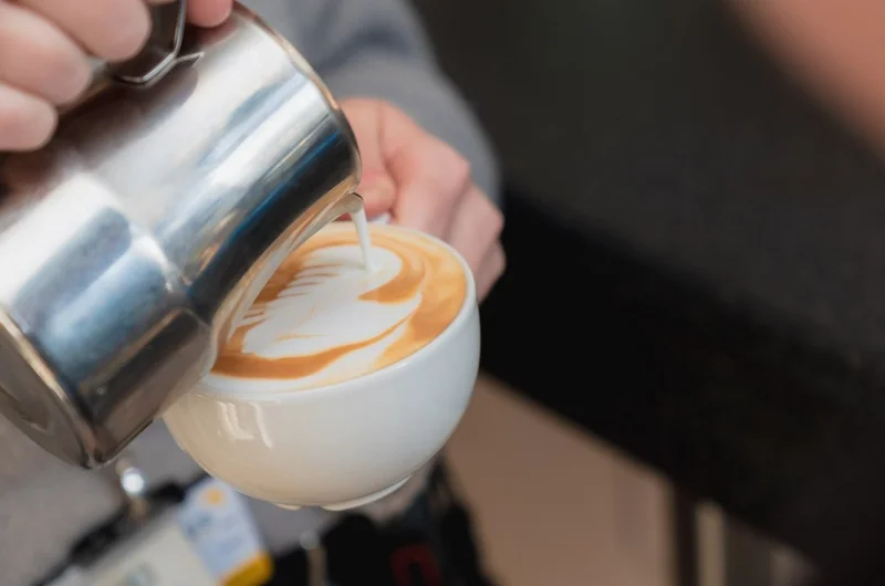 Close-up of a person pouring a freshly made coffee