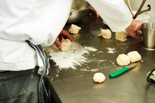 Close-up of someone preparing food in a kitchen