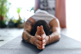 A man stretches in a yoga pose