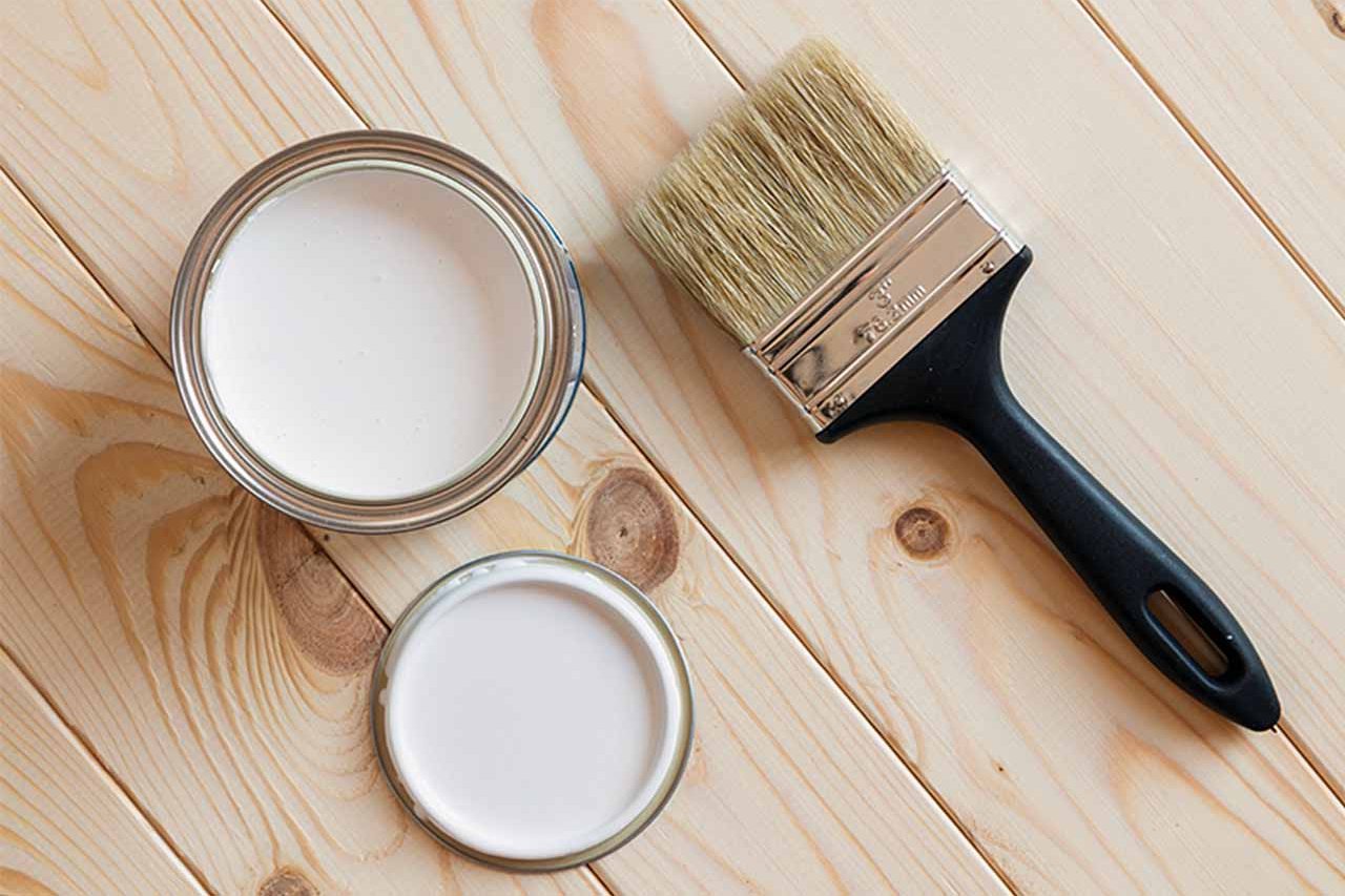 Close-up of a paint brush and paint pot