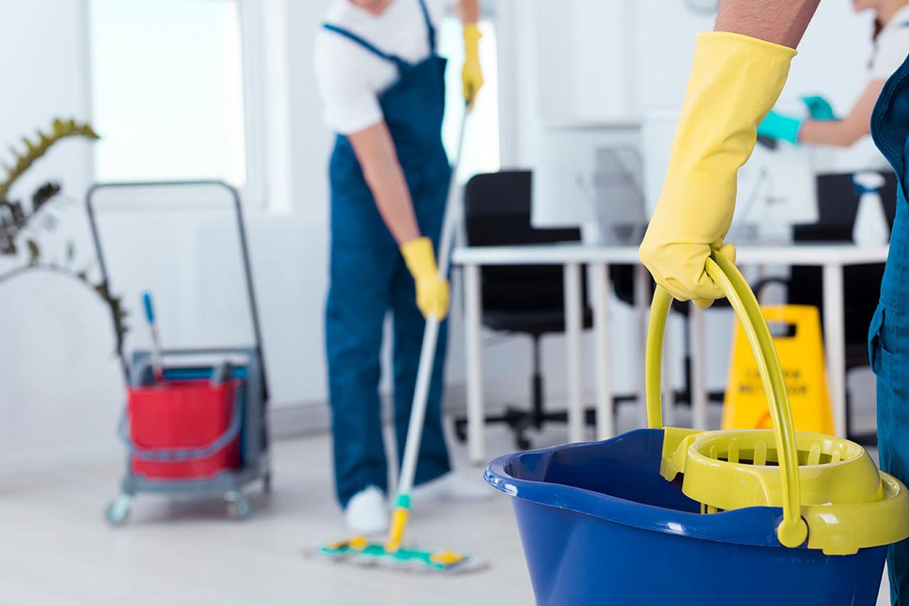 Two people holding cleaning equipment