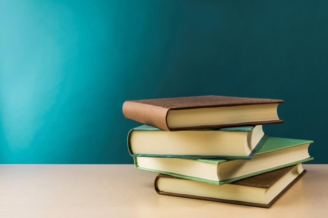 Books stacked on top of each other on a table