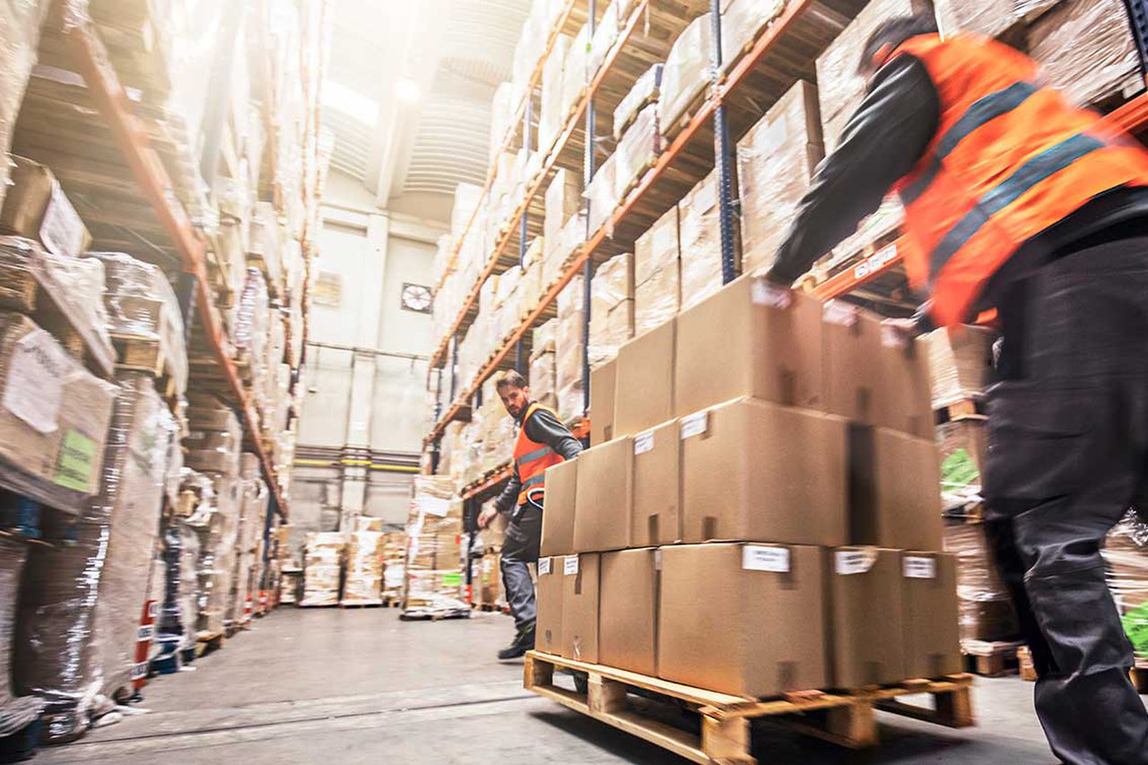 Someone moving pallets in a warehouse