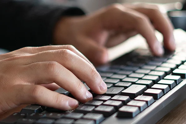 Novus learner using keyboard for digital skills training.
