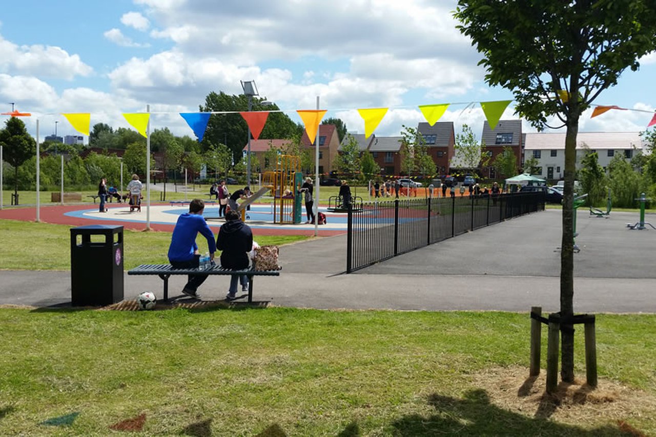 People sitting on a bench in Salford park