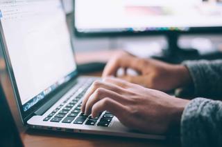 A person typing on a laptop