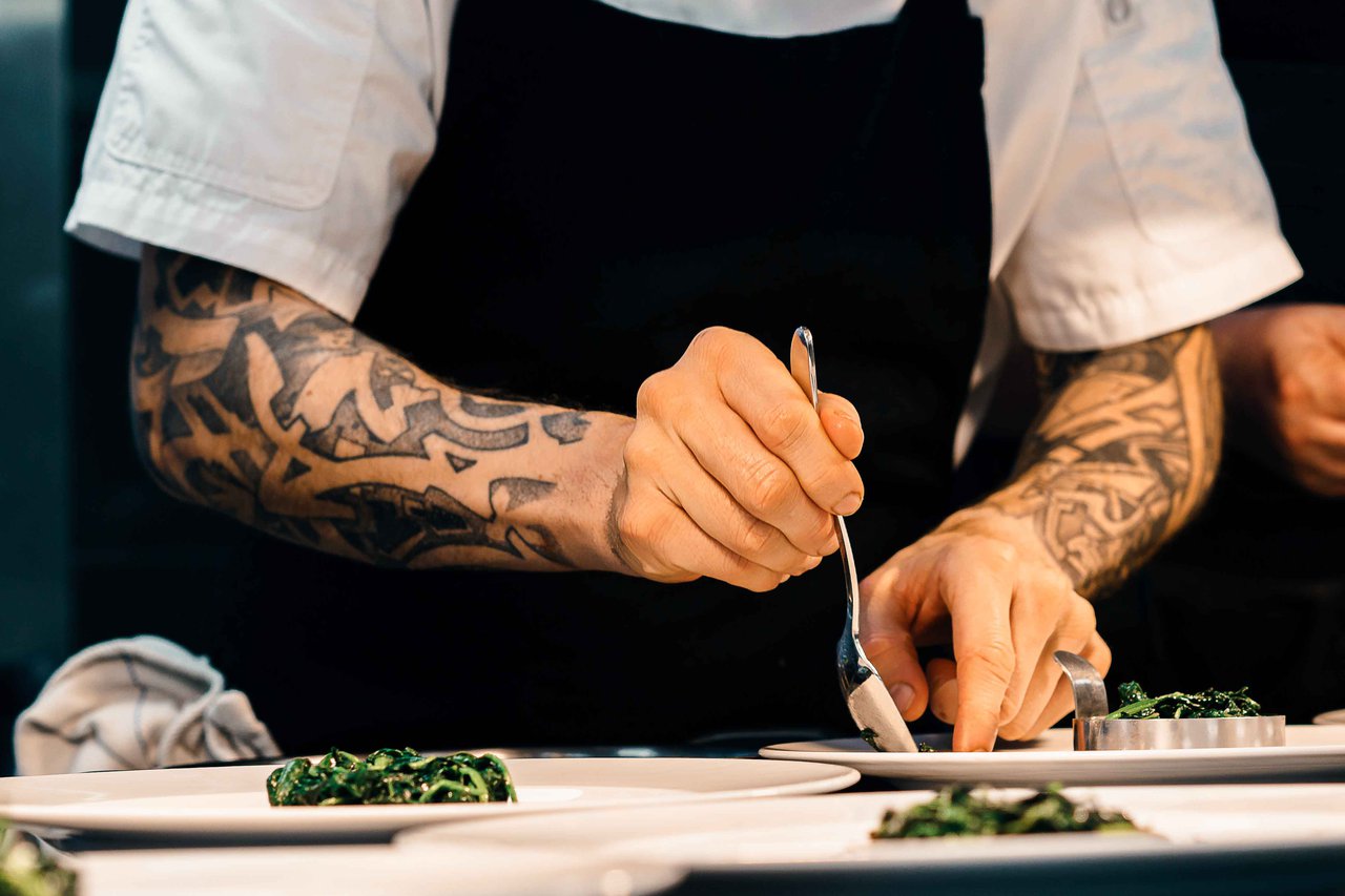 Chef with tattoos cooking