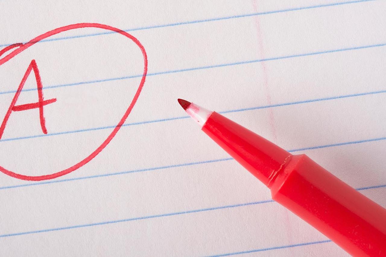 A pen writing 'A on a piece of paper