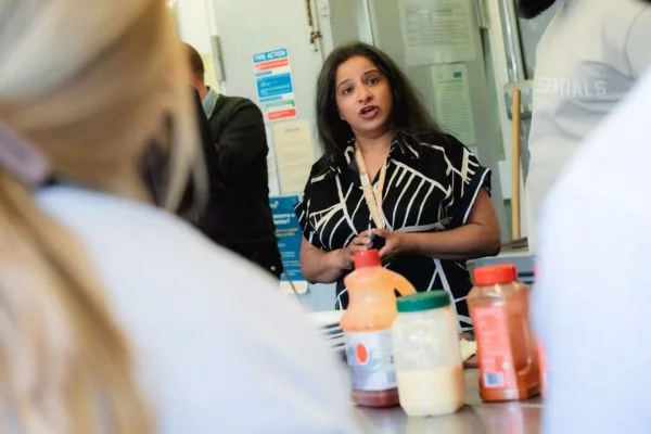 Novus staff member talking to learners