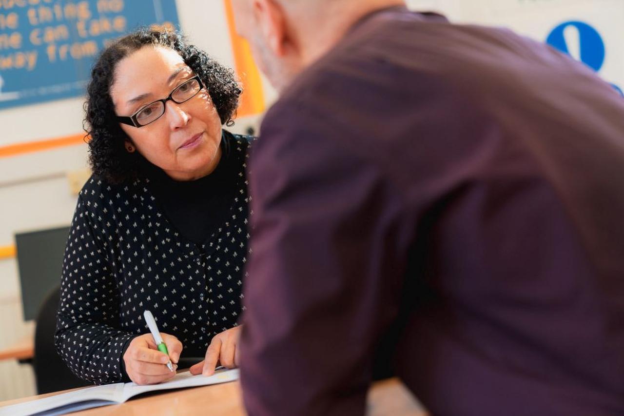 Novus support worker speaking to learner