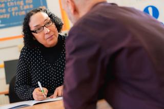 Novus support worker speaking to learner