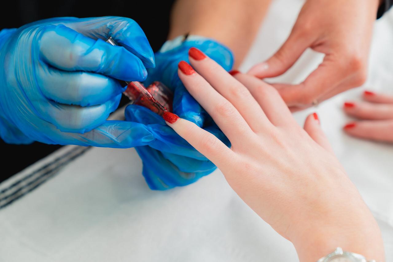 Close up of a Novus learner painting someone's nails.