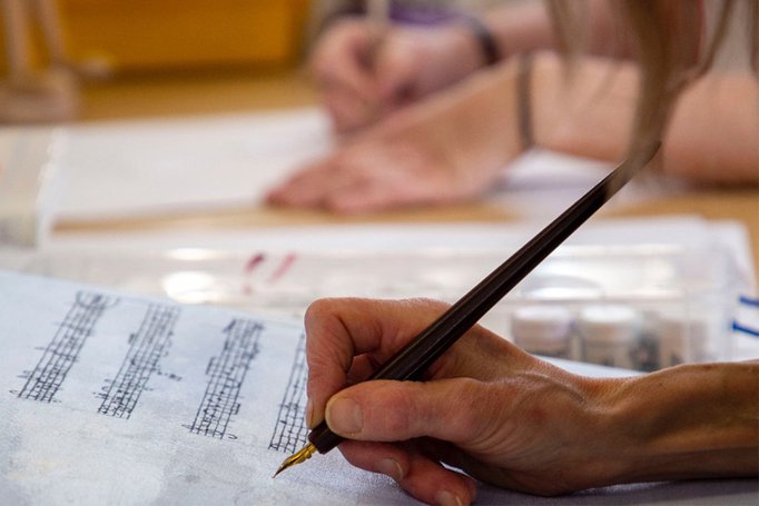 Close-up of hands writing