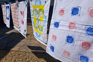 Flags made by Novus Cambria learners hung up on a line