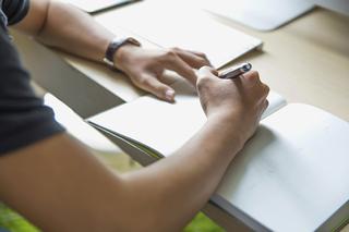 Over-the-shoulder view of someone writing