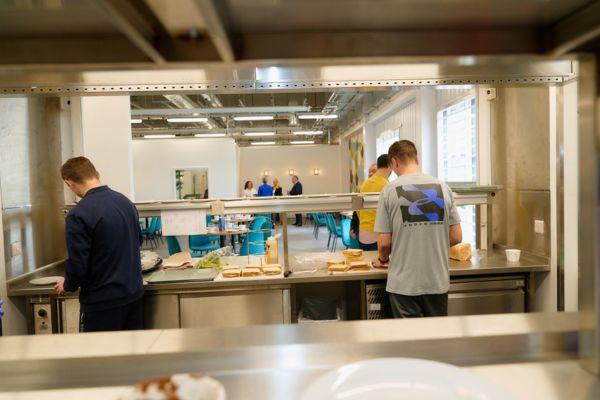 Workers preparing food in a kitchen at a prison